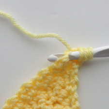 step two of the scdc crochet decrease, where a yarn over is made before inserting the hook in the second stitch