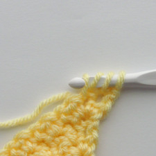 step three of the scdc crochet decrease where a loop is pulled up in the second stitch