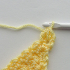 the fifth and final step of the scdc crochet decrease, where there is a yarn over pulled through the three loops on the hook